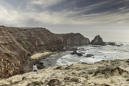 Scenic view of the rugged cliffs and the Atlantic Ocean at Cabo San Vicente, Portugal. The unique...