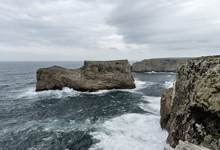 Scenic view of the rugged cliffs and the Atlantic Ocean at Cabo San Vicente, Portugal. The unique...