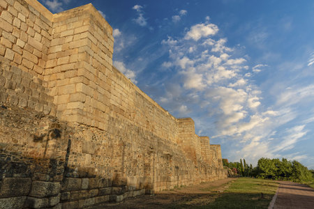 The towering stone walls of the Alcazaba in Merida, Spain, bathed in the warm light of the setting sun.の写真素材