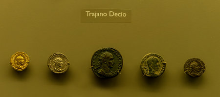 Collection of Roman coins featuring Emperor Trajan Decius. Display showcases detailed portraits and inscriptions of the ancient Roman ruler.の写真素材
