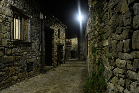 Charming stone alley at night with bright lights