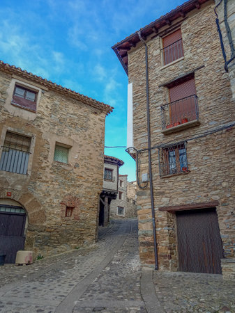 Rustic stone houses along a narrow cobbled street in Yanguas, Soria, showcasing traditional Spanish village architecture.の写真素材