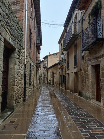 Wet cobblestone street in the medieval town of Laguardia, Alava, Spainの写真素材