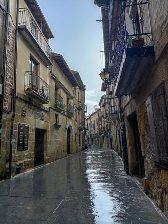 Wet cobblestone street in the medieval town of Laguardia, Alava, Spainの写真素材