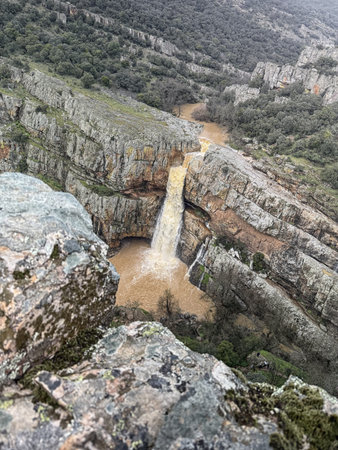 Cascada de la Cimbarra, a stunning waterfall in Spain, cascades over rugged cliffs with powerful water flow, creating a dramatic natural scene.の写真素材