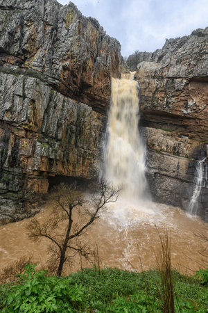 Cascada de la Cimbarra, a stunning waterfall in Spain, cascades over rugged cliffs with powerful water flow, creating a dramatic natural scene.の写真素材