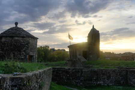 Silhouette of Jaca Citadel at Dawn with Sun Raysの写真素材