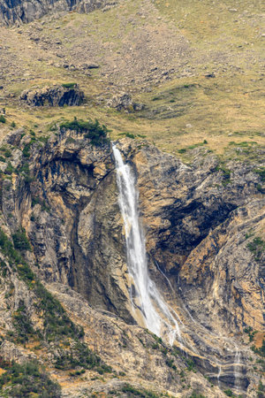 Waterfall in the middle of a vibrant autumn forest in the Pineta Valleyの写真素材