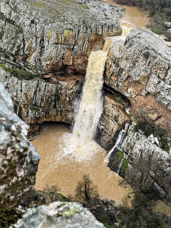 Cascada de la Cimbarra, a stunning waterfall in Spain, cascades over rugged cliffs with powerful...