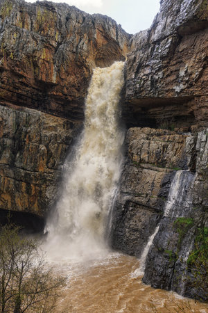 Cascada de la Cimbarra, a stunning waterfall in Spain, cascades over rugged cliffs with powerful water flow, creating a dramatic natural scene.の写真素材