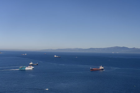 Multiple ships crossing the Strait of Gibraltar under clear blue skies and calm sea.の写真素材