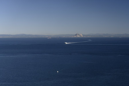 Multiple ships crossing the Strait of Gibraltar under clear blue skies and calm sea.の写真素材