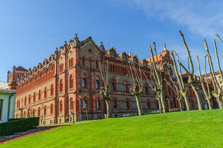 A stately historic mansion set against the daytime in the lush landscape of Comillas, Cantabria, Spainの写真素材