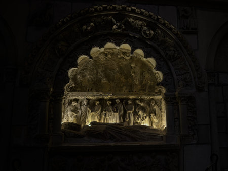 Illuminated stone relief of a medieval tomb sceneの写真素材