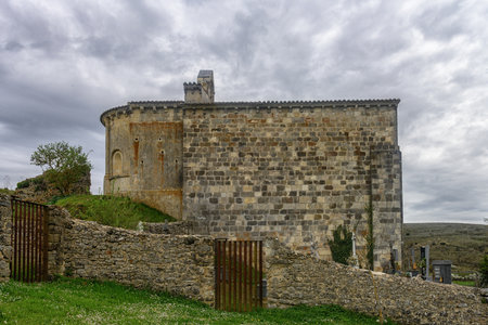 Exterior view of the Romanesque Hermitage of Santa Cecilia with stone walls and apse in Palencia, Spain.の写真素材
