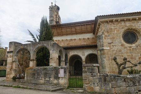 Exterior of San Andres Church with stone tower and ancient arches in Spain.の写真素材