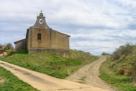 Back view of old stone church with pitched roof in a quiet Spanish village.の写真素材