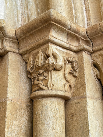 Carved Romanesque capital on the portal of a historic church in Spain.
