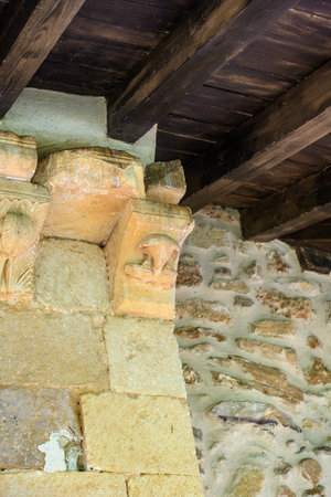 Stone corbel with carved figure. Close-up of Romanesque stone corbel carved with a human figure...