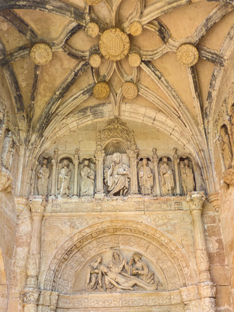 Intricately carved tympanum and vault with biblical scenes in Spanish church entranceの写真素材