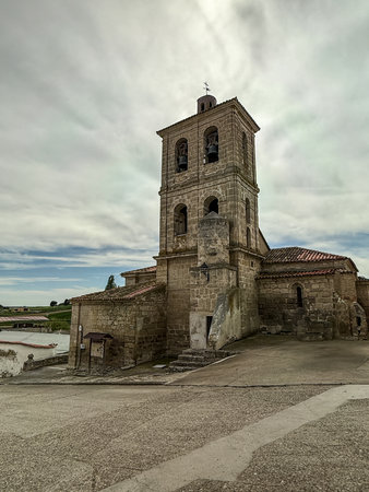 Historic stone bell tower with arched windows and visible bells in Quintanilla de Triguerosの写真素材