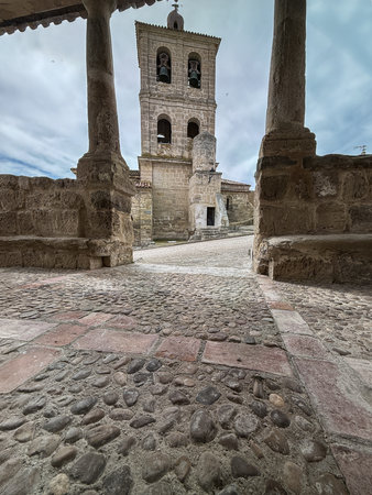 Historic stone church with portico and bell tower in the village of Quintanilla de Triguerosの写真素材