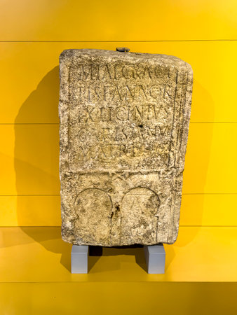 Funerary Roman stele with Latin text and symbolic arched reliefsの写真素材
