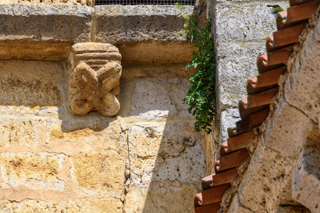 Close-up of sculpted corbels on the church of San Cornelio y San Cipriano in San Cebrian de Camposの写真素材