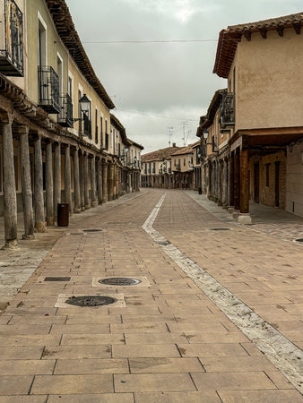 Covered street with wooden columns and stone floor in the historical center of Ampudia, Palenciaの写真素材