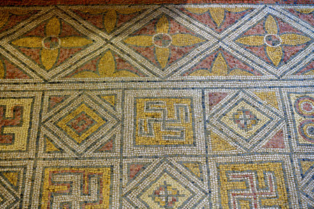 Detailed Roman mosaic with floral and geometric patterns in an archaeological floor settingの写真素材