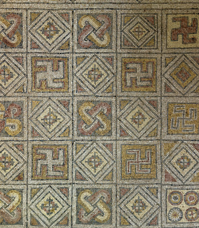 Detailed Roman mosaic with floral and geometric patterns in an archaeological floor settingの写真素材