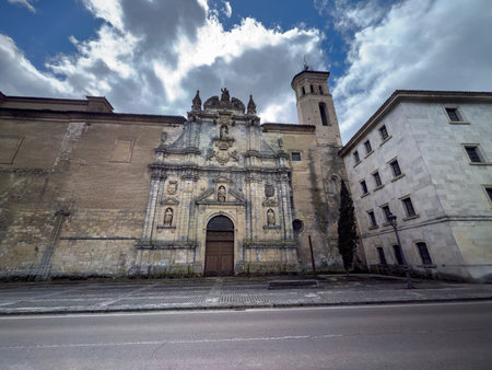 Impressive baroque-style stone facade of a historic monastery with sculptures and towerの写真素材