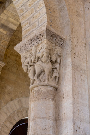 Detailed stone carvings on medieval columns inside Romanesque church