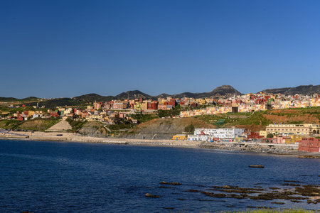 Panoramic view of El Principe in Ceuta with colorful houses and coastal backdrop.