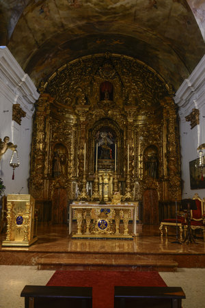 Baroque golden altar inside Santa Maria de Africa church, featuring religious figures and detailed carvings.の写真素材