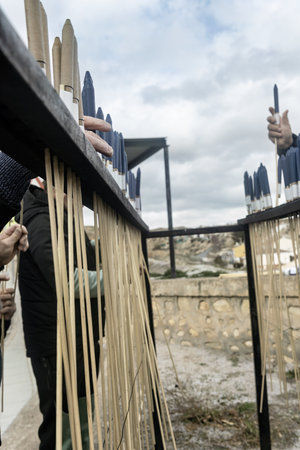 People preparing traditional rockets for a local festivity using wooden racksの写真素材