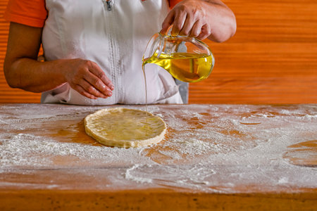 Baker kneading an oil cakeの写真素材