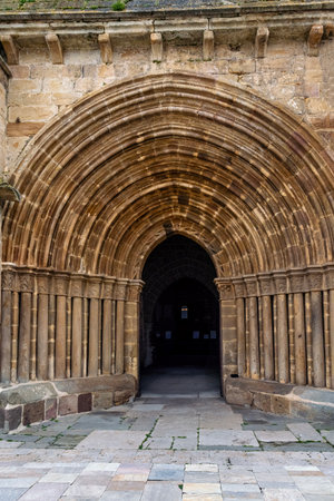 Close-up of Romanesque stone arch with detailed columns at the entrance of an ancient church.の写真素材