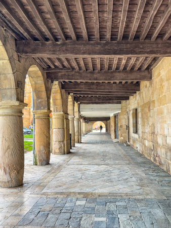 Stone arcade with columns and wooden ceiling in the historic center of Aguilar de Campoo.の写真素材