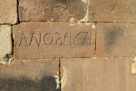 Detail of engraved stone inscription marking the year 1671 on old wallの写真素材