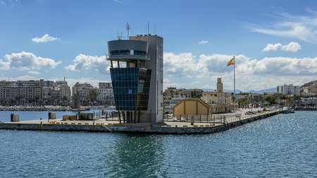 Panoramic view of the Port of Ceuta with maritime tower, city skyline, and flag.の写真素材