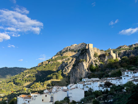La Iruela castle rising over a whitewashed village and forested mountain slopesの写真素材