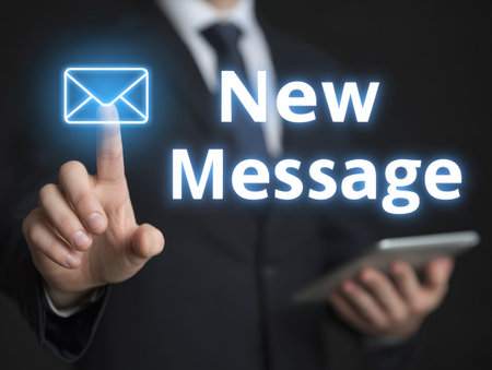 Businessman using modern digital interface to access a new email message notification, representing communication and technology in the workplace.の素材