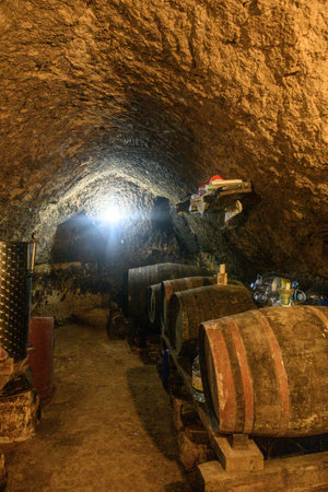 Rustic wine cellar with barrels, tanks and tools in Cordovilla la Real, Palencia, Spain