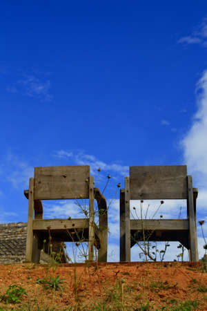 Two old wood chair with blue skyの写真素材