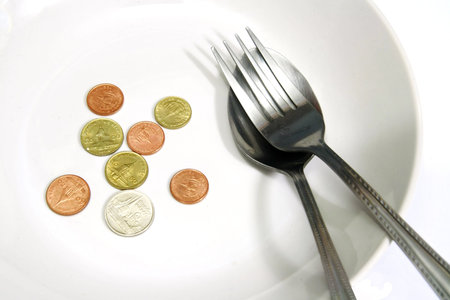 Asia coins in white plate with spoon