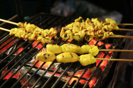 squid with yellow source grill on BBQの写真素材