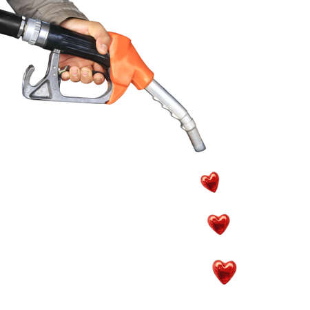 Male hand holding gas pump and red heart drop の写真素材