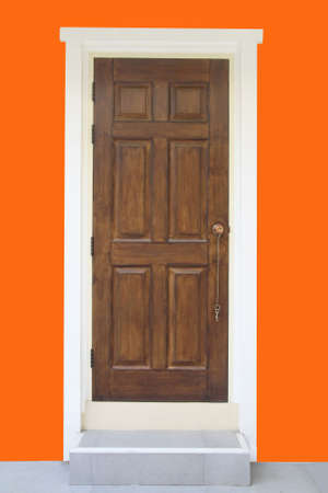 wood door and orange wall の写真素材