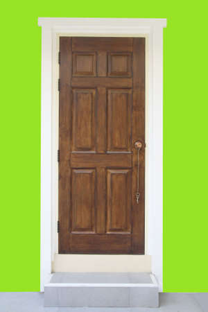 Brown wood door with green wall の写真素材